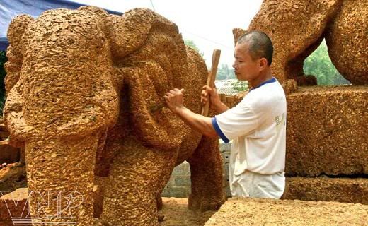 Artisan Tran Van Nghiem carves laterite into a giant elephant. Artisan Tran Van Nghiem carves laterite into a giant elephant.