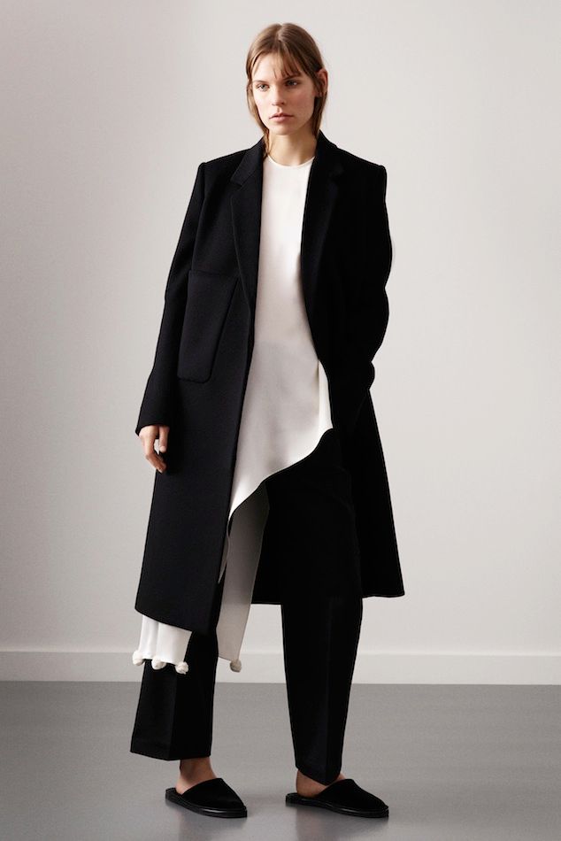 Le Fashion Blog Ports 1961 FW 2015 Minimal Long Black Coat White Asymmetrical Top With Pom Pom Hem Cropped Pants Slippers photo Le-Fashion-Blog-Ports-1961-FW-2015-Minimal-Long-Black-Coat-White-Asymmetrical-Top-With-Pom-Pom-Hem-Cropped-Pants-Slippers.jpg