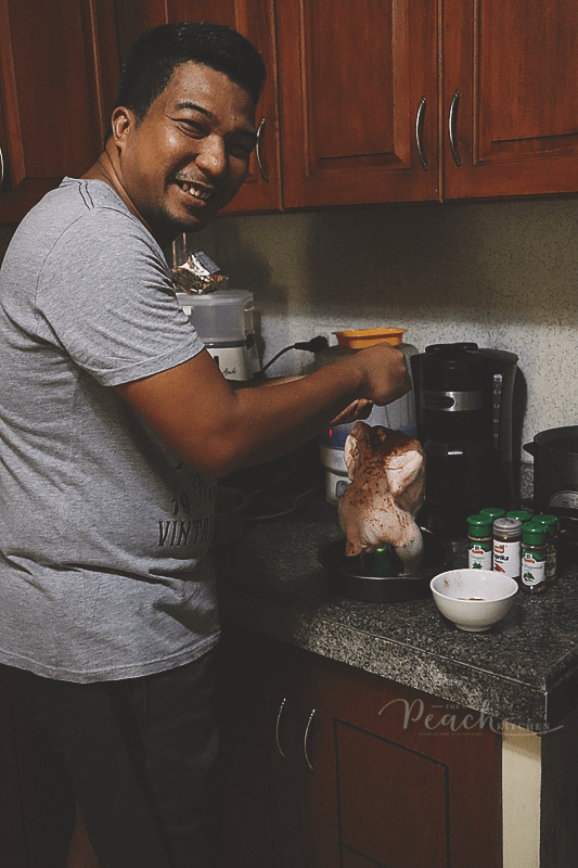 husband marinating beer can chicken