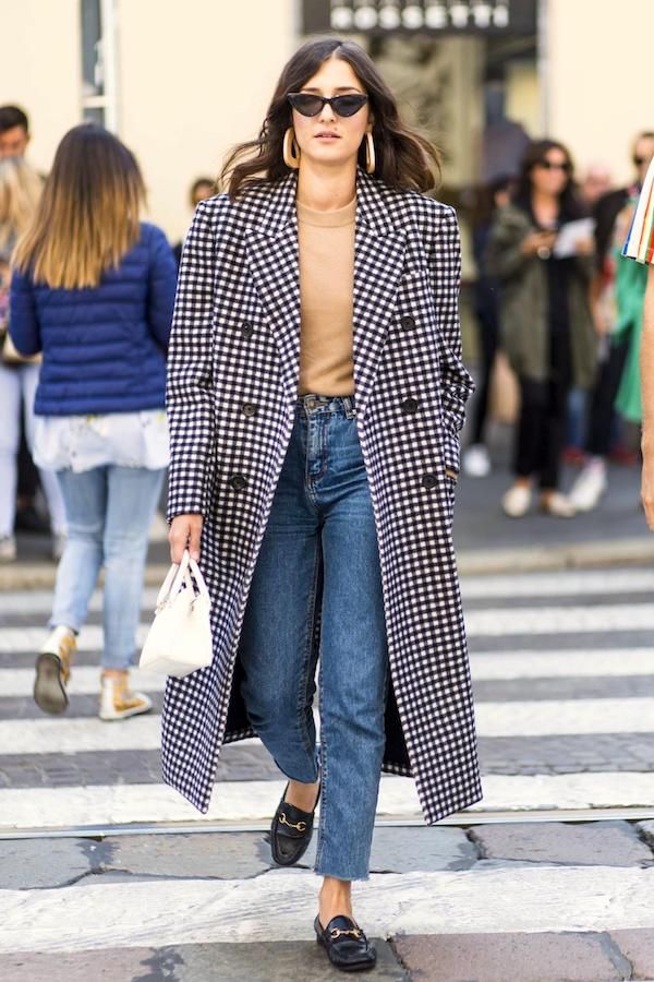 A Polished Denim Outfit Idea to Try Now — Eleanora Carisi in a checkered coat, raw-hem jeans, and loafers