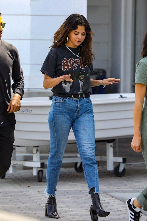 Le Fashion Blog Selena Gomez Band T Shirt Black Step Hem Jeans Black Heeled Boots Via Vogue 