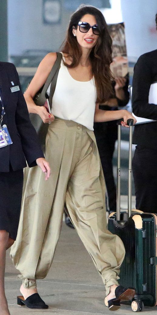 Le Fashion Blog Amal Clooney Airport Style Sunglasses White Tank Top Khaki Harem Pants Black Mules Via Instyle 