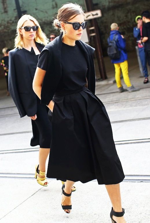 Le Fashion Blog Street Style All Black Ladylike Minimal Spring Look Australia Fashion Week Sydney Style Low Bun Cat Eye Sunglasses Sweater Over Shoulders Classic Black Tee T-shirt Full Skirt Culottes Gaucho Style cropped Wide Leg Pants Ankle Strap Sandals Via Vogue photo Le-Fashion-Blog-Street-Style-All-Black-Ladylike-Minimal-Spring-Look-Australia-Fashion-Week-Via-Vogue.jpg