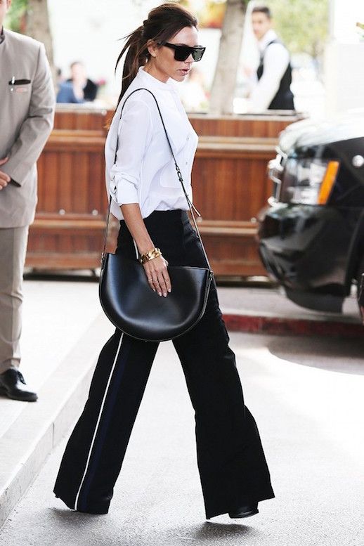 Le Fashion Blog Celebrity Style Victoria Beckham Sunglasses White Tuxedo Shirt Leather Shoulder Bag Side Stripe Wide Leg Pants Via Who What Wear