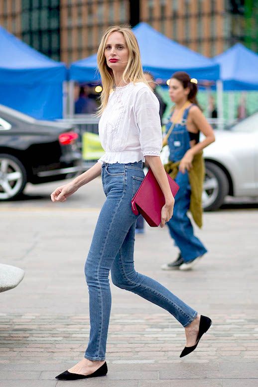 Le Fashion Blog Street Style White Eyelet Top Pink Clutch High Waisted Skinny Jeans Black Pointed Toe Flats Via Harpers Bazaar